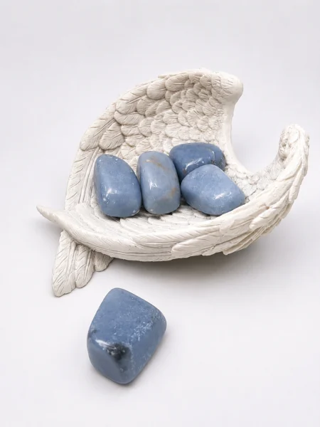 Polished Angelite tumble stone with soft blue colouring and natural markings