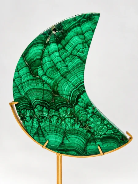 Close-up of polished Malachite crescent moon showing natural concentric green banding and patterns