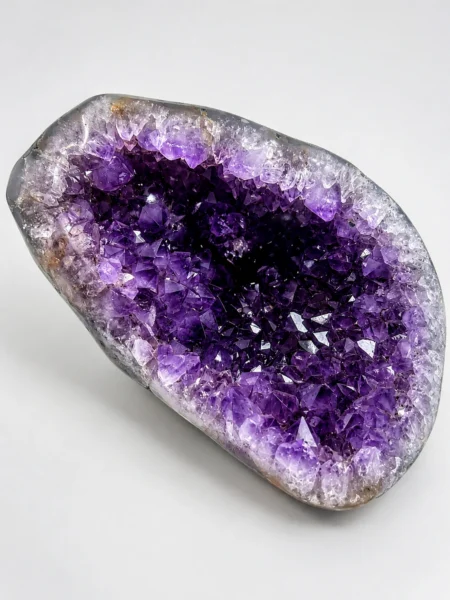 Natural Amethyst geode specimen showing deep violet and lavender crystal points