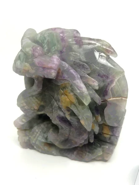 Rainbow Fluorite dragon carving showing translucent green purple and golden natural mineral patterns